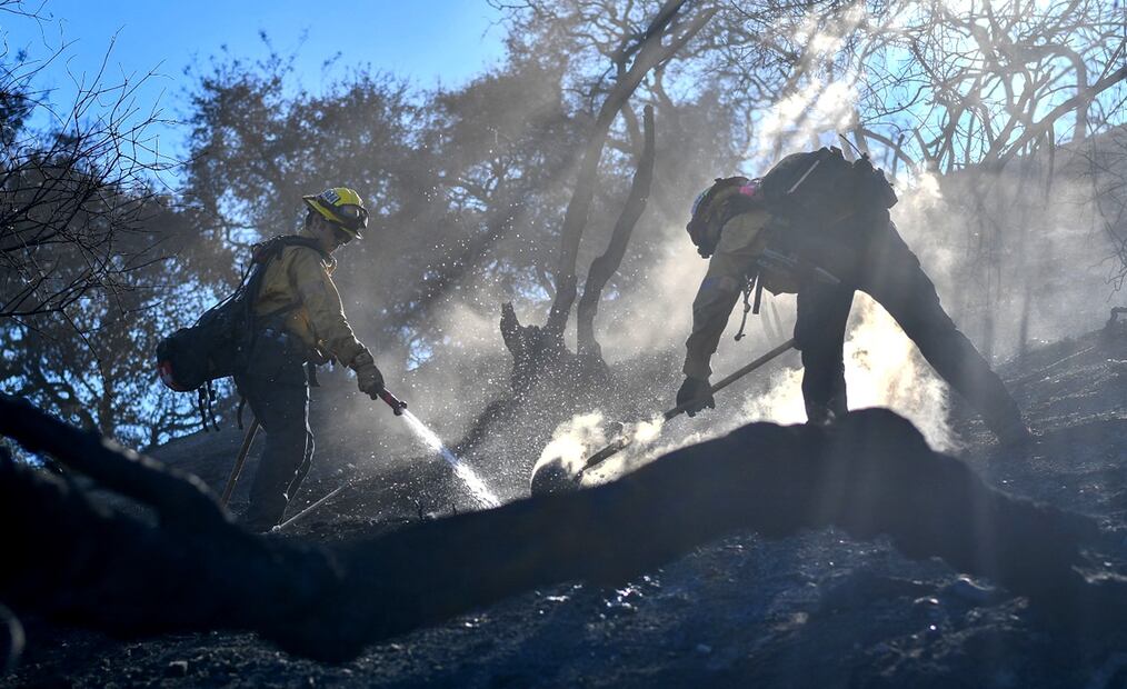 Equipos de búsqueda rescatan a las personas fallecidas en los devastadores incendios de Los Ángeles al desplazarse de casa en casa; mientras, bomberos se preparan para los vientos huracanados que podrían avivar los incendios, el 13 de enero de 2025. Foto: AFP